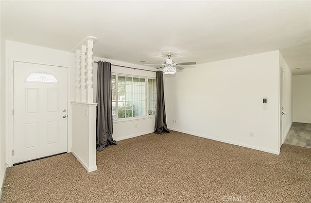 foyer with ceiling fan and carpet floors