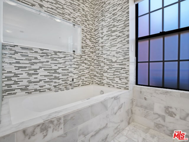 bathroom with tiled bath