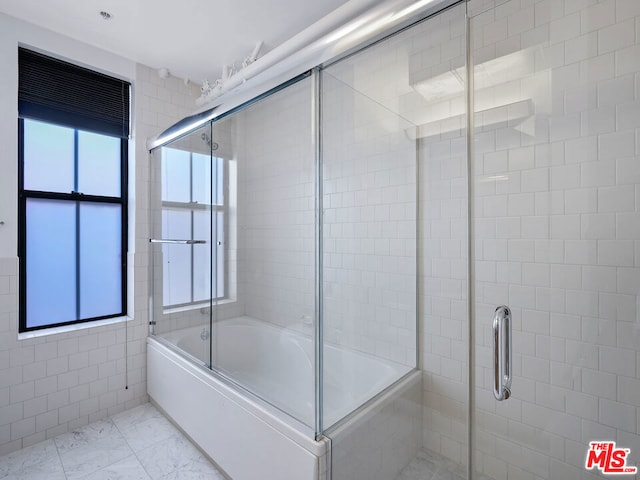 bathroom with plenty of natural light and enclosed tub / shower combo