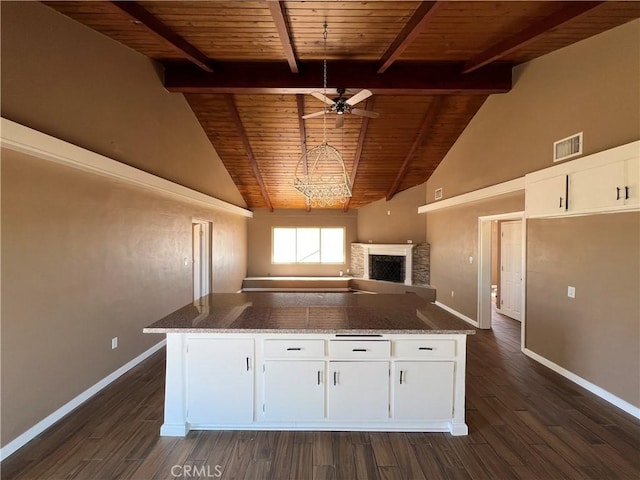 kitchen featuring wood ceiling, ceiling fan, stone countertops, dark hardwood / wood-style floors, and white cabinetry