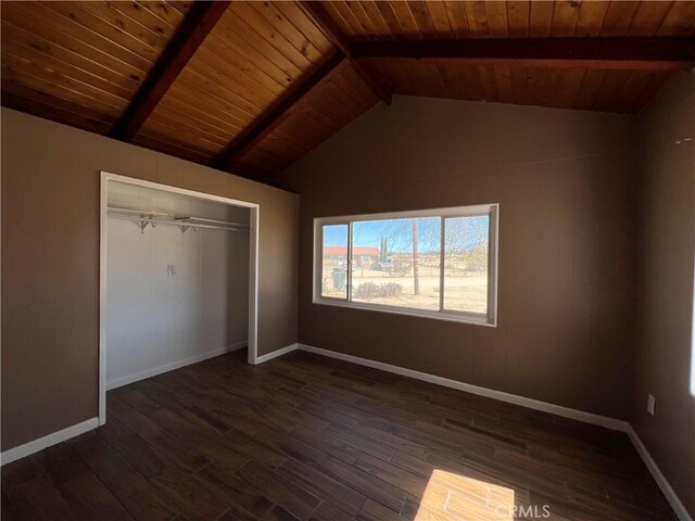 unfurnished bedroom with vaulted ceiling with beams, a closet, dark wood-type flooring, and wood ceiling