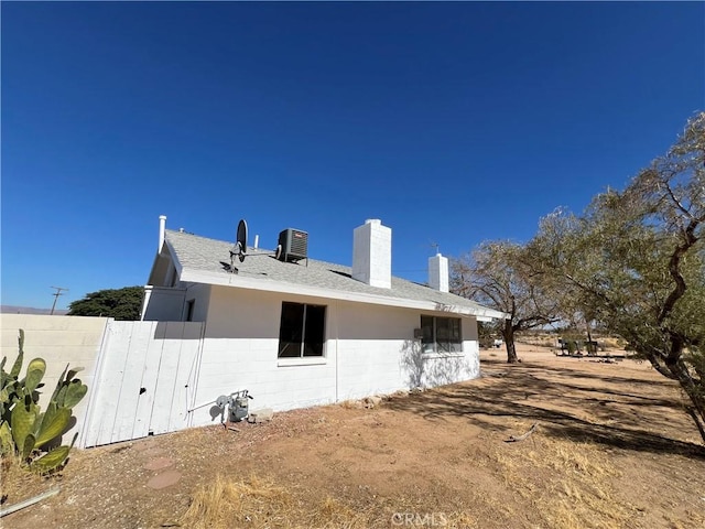 back of house featuring central AC unit