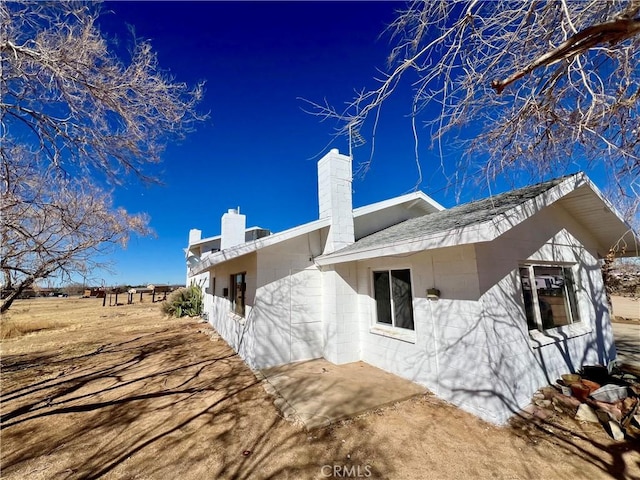 view of home's exterior with a patio and central AC