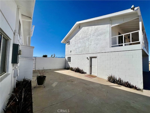 view of property exterior with a patio