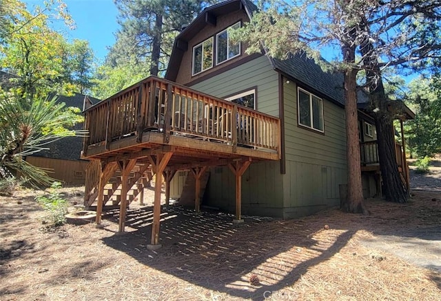 rear view of house with a wooden deck