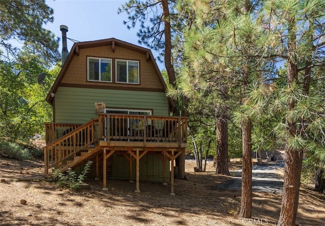 back of property featuring a wooden deck