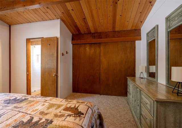 carpeted bedroom with connected bathroom, beam ceiling, a closet, and wooden ceiling