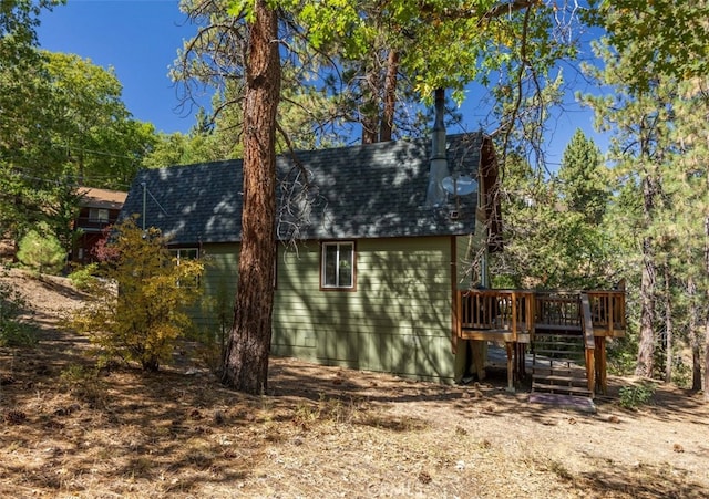 back of property with a wooden deck