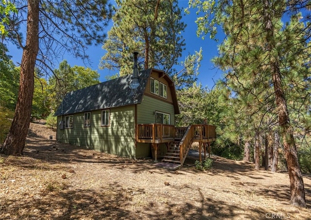 rear view of house with a wooden deck