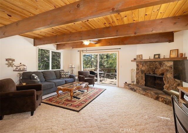 carpeted living room featuring wooden ceiling, a stone fireplace, ceiling fan, and beamed ceiling