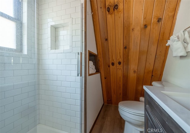 bathroom with vanity, hardwood / wood-style flooring, toilet, and a shower with door