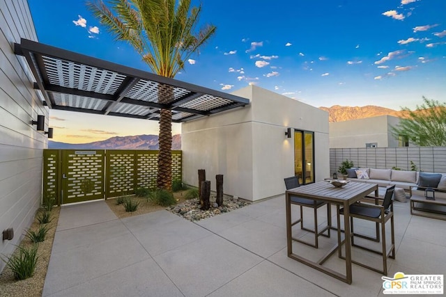 view of patio featuring a mountain view, an outdoor hangout area, and a pergola