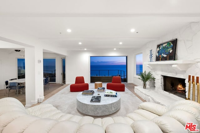 living room with light wood-type flooring and beamed ceiling