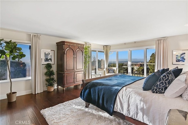 bedroom with access to outside, baseboards, and dark wood finished floors