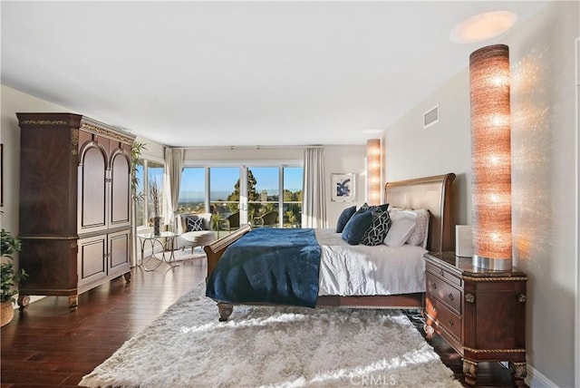 bedroom with dark wood-type flooring and visible vents