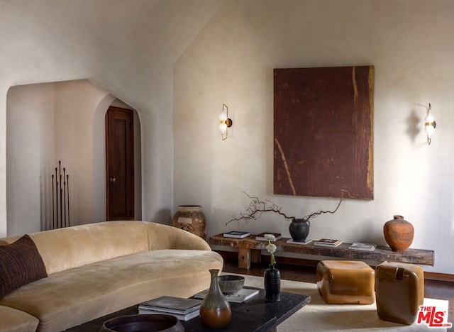 living room with vaulted ceiling and hardwood / wood-style flooring