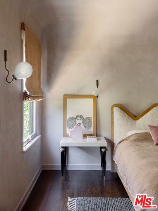 bedroom with dark hardwood / wood-style floors