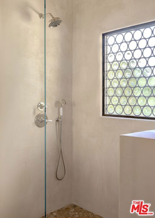 bathroom with a tile shower