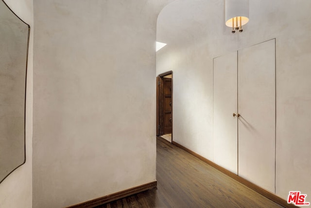 hallway with dark hardwood / wood-style flooring