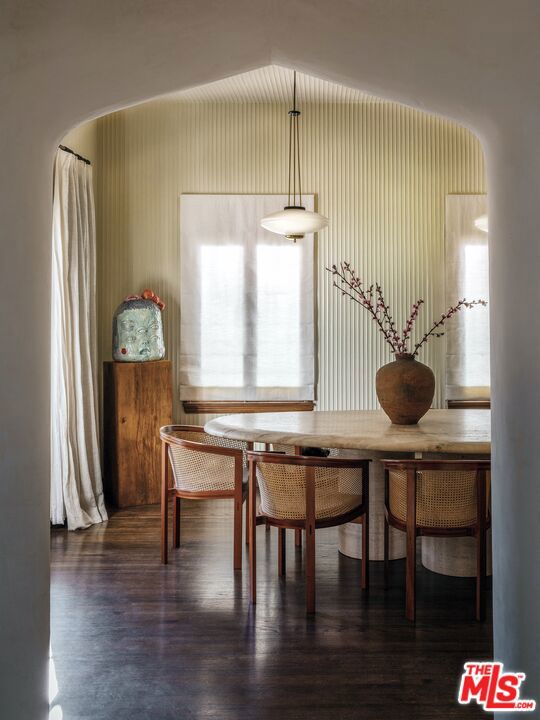 dining room featuring lofted ceiling and dark hardwood / wood-style flooring