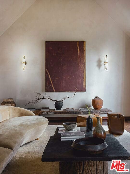 living room with high vaulted ceiling and hardwood / wood-style flooring