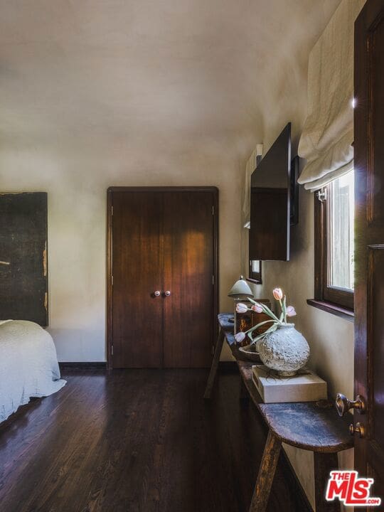 interior space featuring dark brown cabinetry and dark hardwood / wood-style flooring