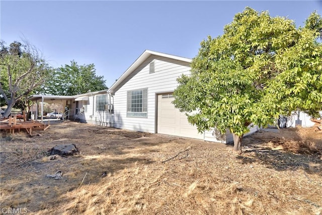 view of side of home with a garage