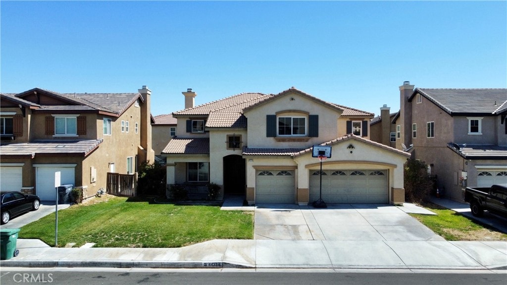 view of front of property featuring a front lawn and a garage