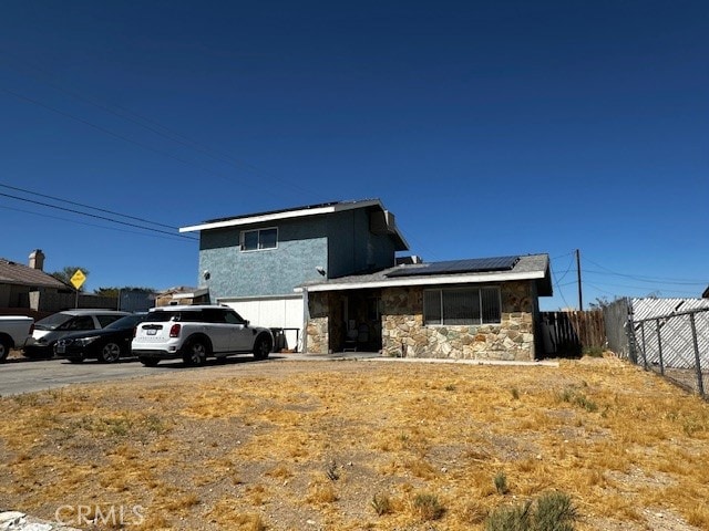 view of front of property with solar panels