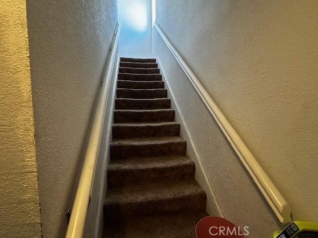 stairs with a textured wall