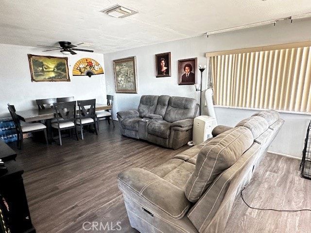 living room featuring wood-type flooring and ceiling fan