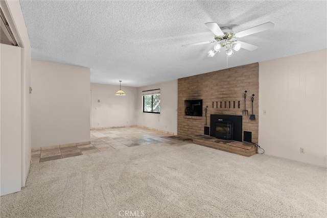 unfurnished living room with a brick fireplace, ceiling fan, light colored carpet, and a textured ceiling