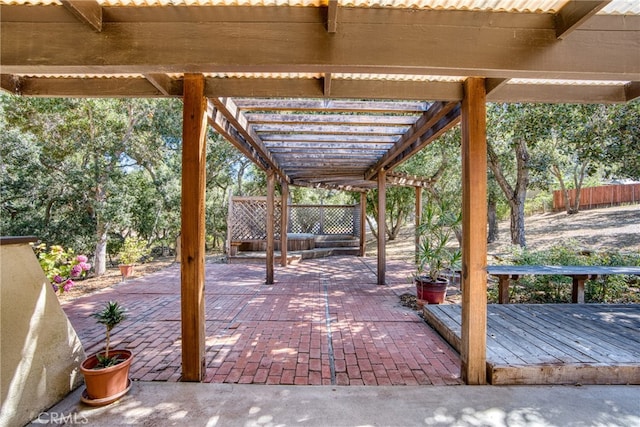 view of patio / terrace featuring a wooden deck and a pergola