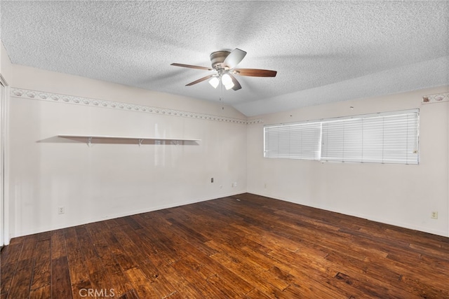 empty room with a textured ceiling, dark hardwood / wood-style flooring, and ceiling fan