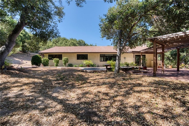 back of house with a pergola and a patio area