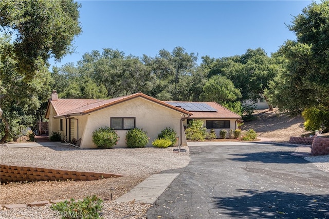 view of front of property with solar panels