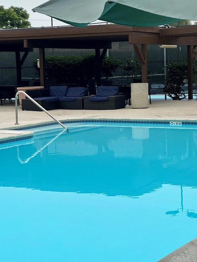 view of swimming pool featuring an outdoor living space and a patio area