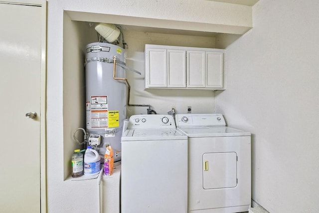 laundry area featuring secured water heater, washing machine and dryer, and cabinets