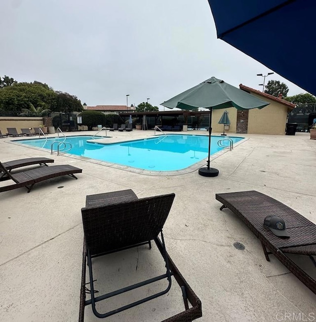 view of swimming pool featuring a patio area