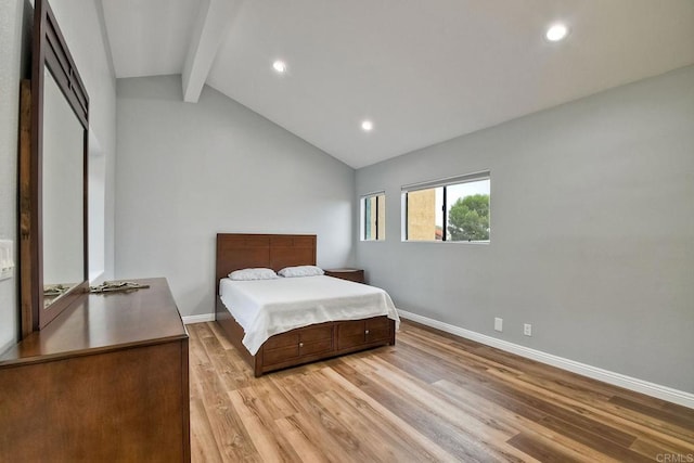 bedroom featuring lofted ceiling with beams and light wood-type flooring