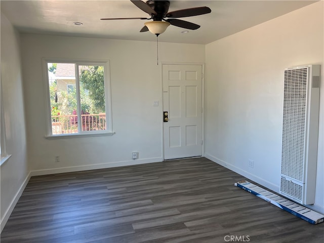 spare room with ceiling fan and dark wood-type flooring