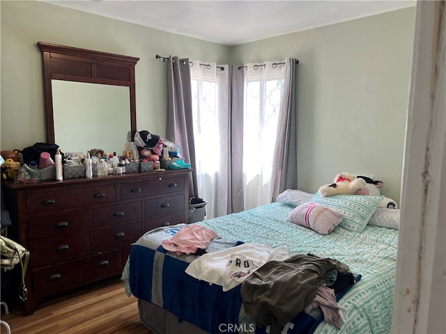 bedroom with hardwood / wood-style flooring