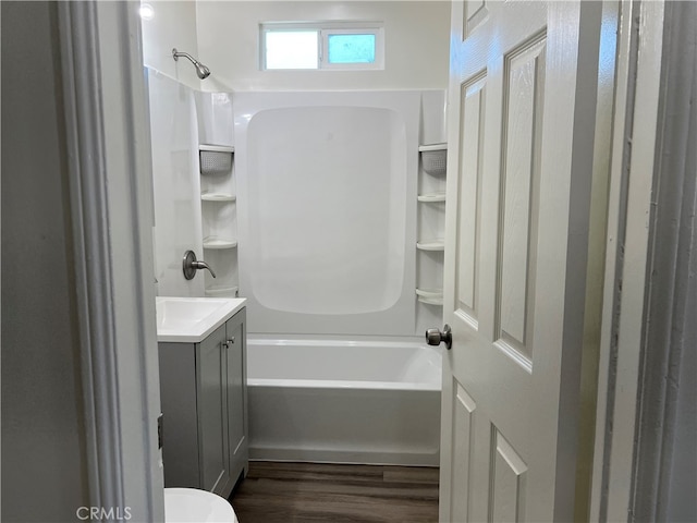 full bathroom with vanity, toilet, bathtub / shower combination, and hardwood / wood-style flooring