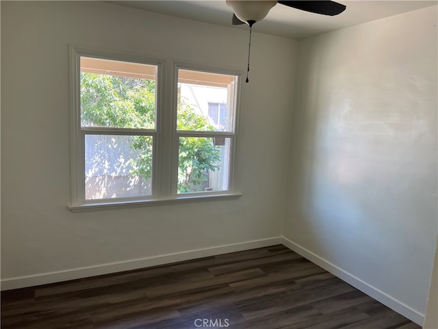 unfurnished room with ceiling fan and dark hardwood / wood-style flooring