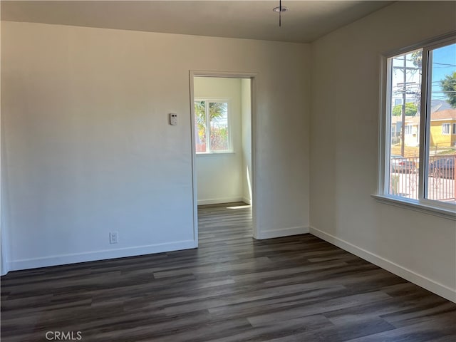 spare room with dark wood-type flooring