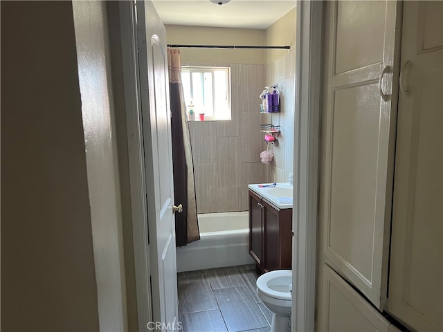 full bathroom featuring shower / bath combo, vanity, and toilet