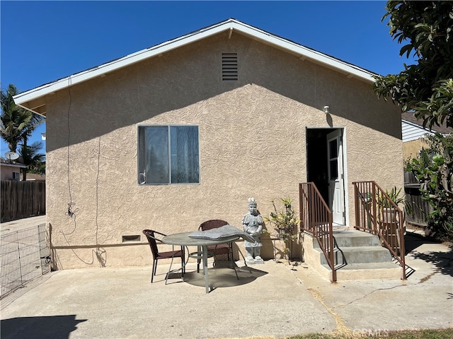 back of property with a patio area