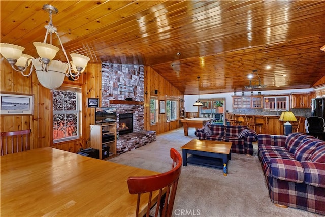 carpeted living area with lofted ceiling, wooden ceiling, a brick fireplace, wood walls, and billiards