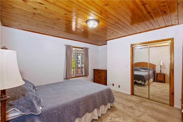 bedroom with crown molding, light colored carpet, wooden ceiling, and a closet