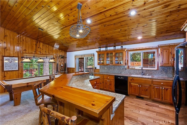 kitchen with a sink, brown cabinets, black appliances, backsplash, and wood ceiling